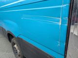 a blue van that is parked on the side of the street