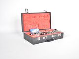 a black suitcase with a red lining and a key in it