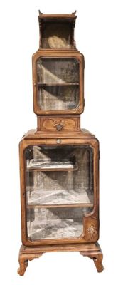 une petite armoire en bois surmontée de portes vitrées