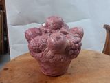 a pink vase sitting on top of a wooden table