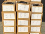several cardboard boxes are stacked on a pallet in front of a black wall