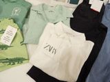 a lot of clothes that are sitting on a table