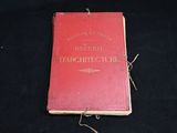 a red book that is laying on a black surface