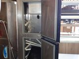 an image of a kitchen with a refrigerator and a sink