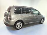 a picture of a silver minivan parked in a garage