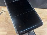 a cell phone sitting on top of a wooden table