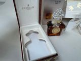 a bottle of whisky in a box next to a bottle of liquor