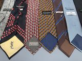 a lot of different ties that are on a table