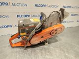 a chainsaw sitting on top of a table in front of a wall
