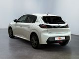 the rear end of a white car parked in a white room