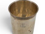 an old silver cup with a monogram on the side