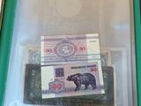 a green folder with money inside of it on a table