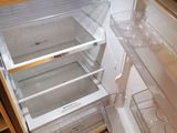 an open refrigerator that is sitting in a kitchen