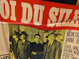 a lot of old movie posters hanging on the wall