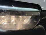 a close up of a car ' s headlight with the light on