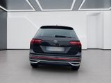 the rear end of a black volkswagen suv in a white room