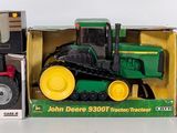 three toy tractors in a box on a table
