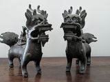 two statues of animals that are on a table