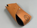 leather case for a cell phone on a white surface