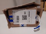 a cardboard box with a sticker on it sitting on a table