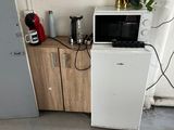 a microwave and a microwave oven in a small room