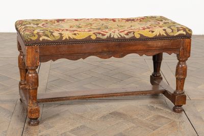un banc en bois avec une assise rembourrée à motifs floraux