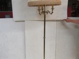 a man standing next to a lamp that is on a stand