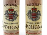 pair of two bottles of wine sitting next to each other on a white surface