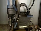 a picture of a drill and other tools sitting on a table