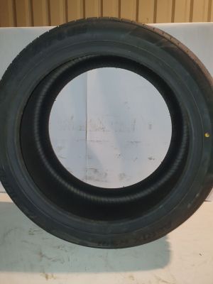 a close up of a tire on a counter with a wall in the background