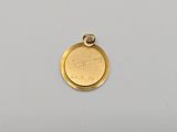 a close up of a gold coin on a white surface