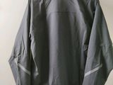 the back of a jacket hanging on a hanger on a wall