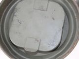 a close up view of a metal container with a lid