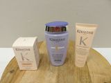 a bottle of kerastase next to a box of cream and a tube of lotion