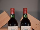 two bottles of wine sitting next to each other on a table