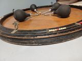 a wooden tray with three black balls on top of it