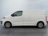 the white van is parked in a parking lot on a cloudy day