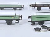 four different types of toy train cars on a white surface
