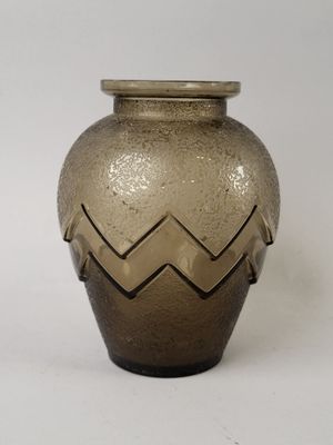 a brown vase with a chevroned design on it