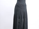 black dress on a mannequin stand against a white background