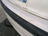 a white car that is parked on the side of the road