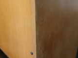 a close up of a wooden cabinet with a drawer underneath it