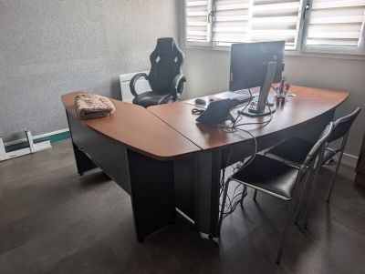 a desk with a chair and a computer on it