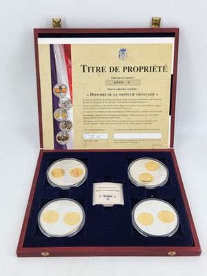 a set of four gold coins in a wooden case