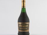 a bottle of wine sitting on top of a white table