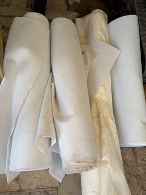 several rolls of toilet paper sitting on top of a wooden floor