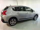 a picture of a small silver car parked in a garage