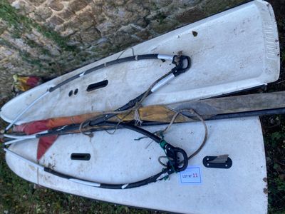 two paddle boards laying on the ground next to each other