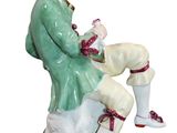 a figurine of a man sitting on a rock