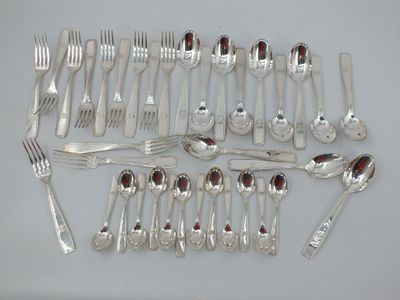 a lot of silver spoons and forks on the table